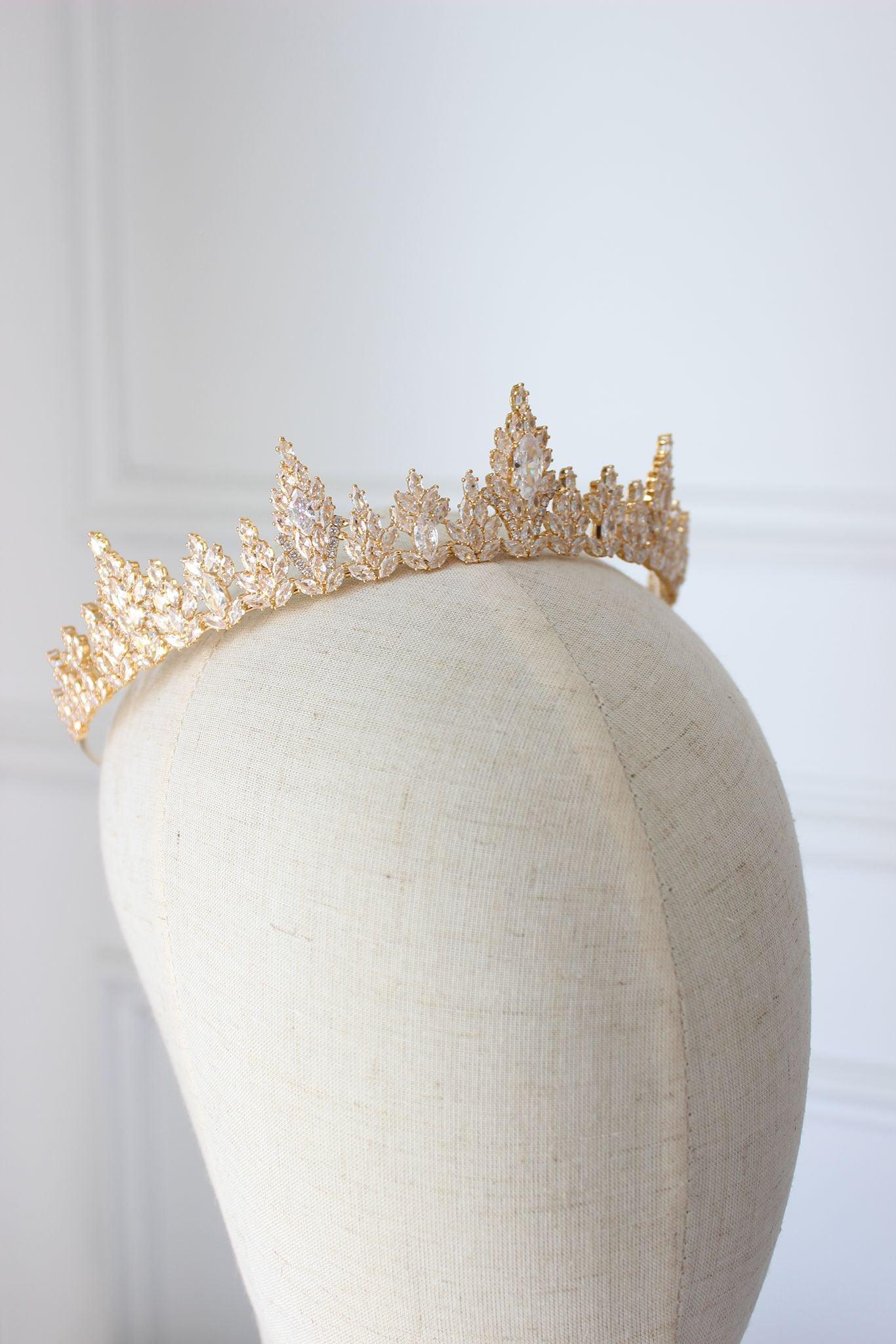 Classic gold bridal tiara with shimmering crystals on display