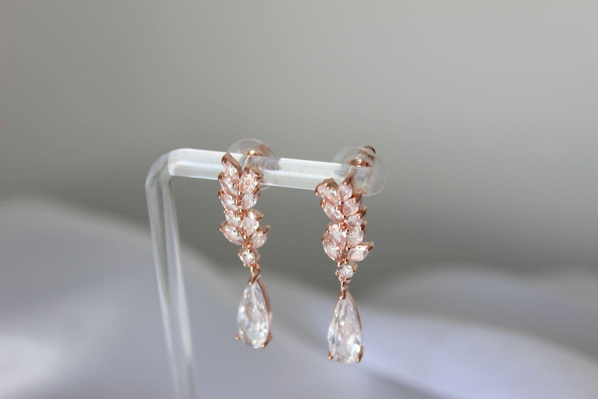 Pear Rose Gold Drop Earrings on Earrings Stand