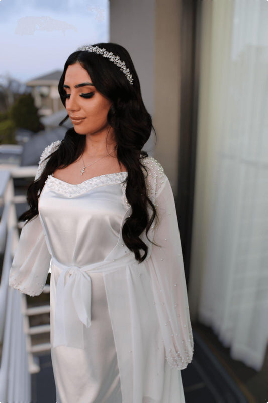 bride wearing Pearl Bridal Slip leaning over balcony