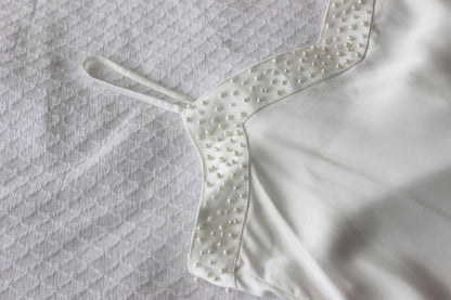Pearl Bridal Slip on white bed sheet