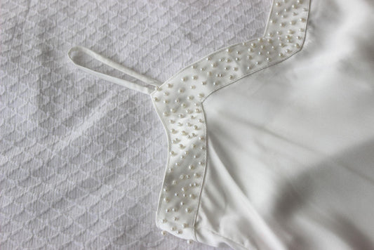 Pearl Bridal Slip on white bed sheet