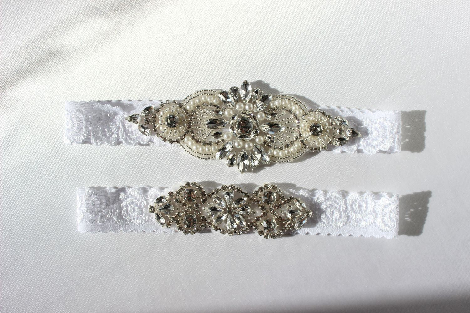 Detailed view of pearl and crystal embellishments on floral lace garter