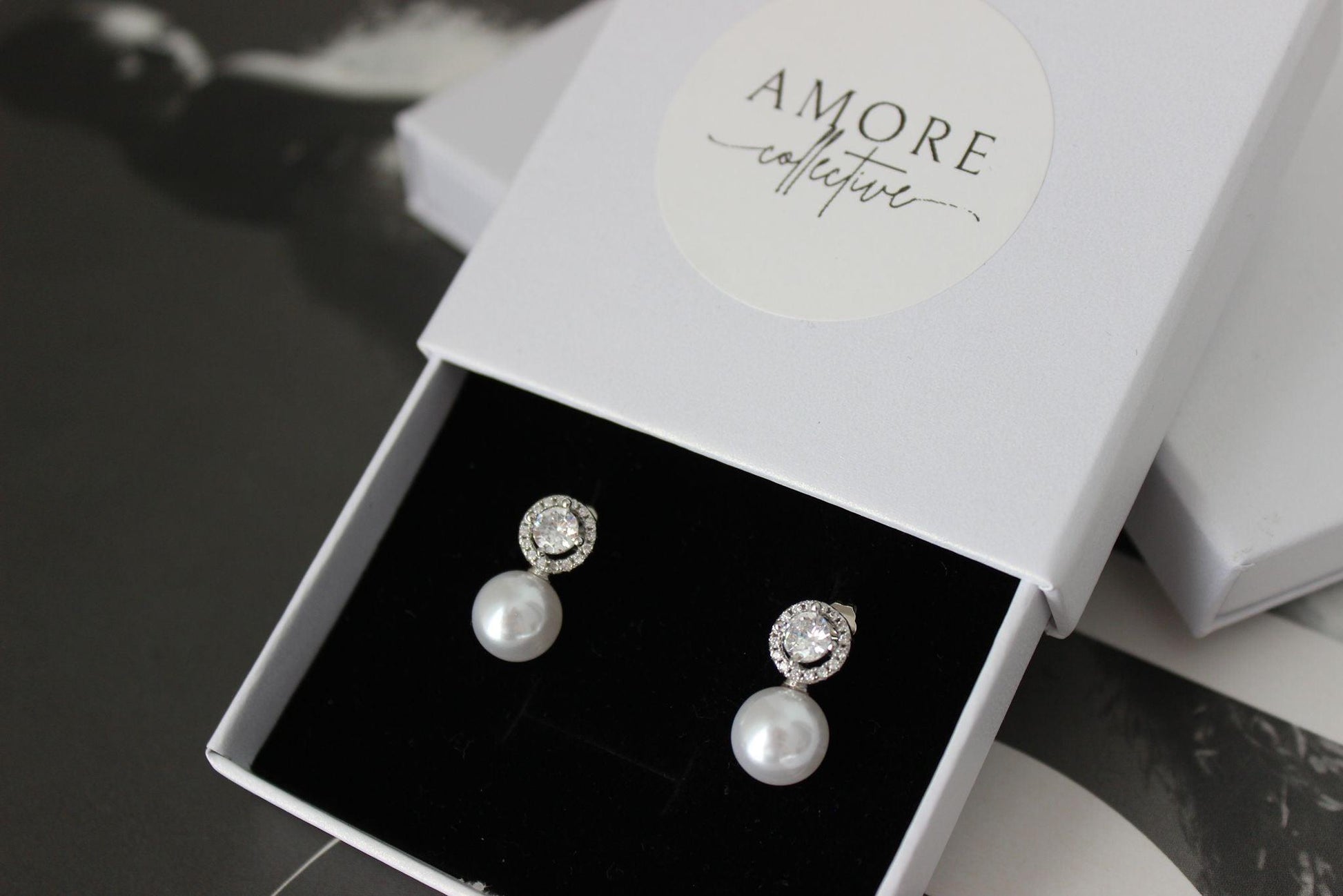 pearl drop silver earrings with cubic zirconia round stone on top