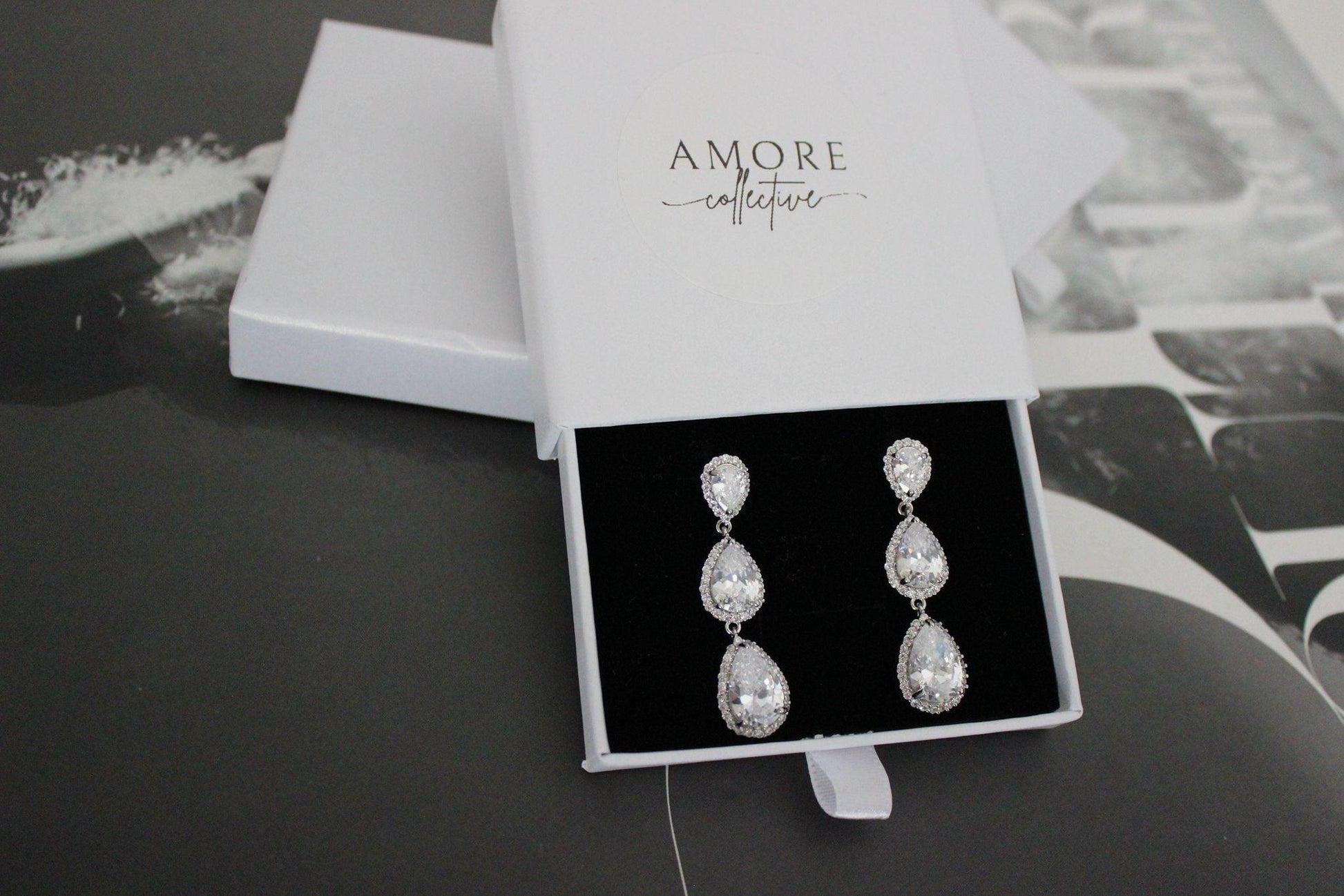 Silver drop earrings with three pear shaped stones