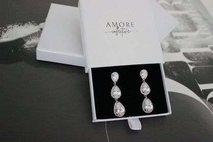 Silver drop earrings with three pear shaped stones