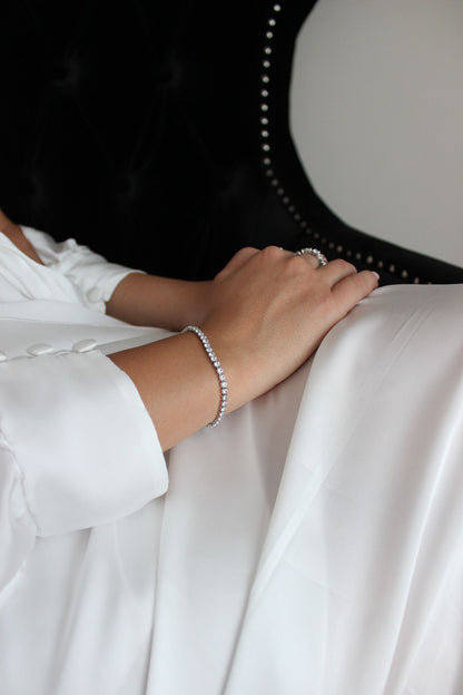 Silver Tennis Bracelet on bride crossing hands over