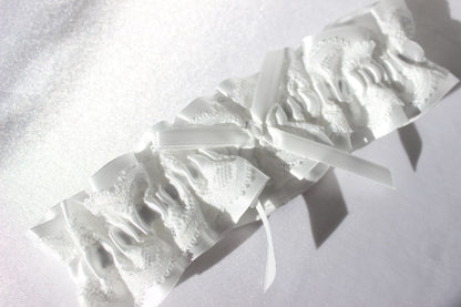Stella white lace bridal garter with ribbon in centre