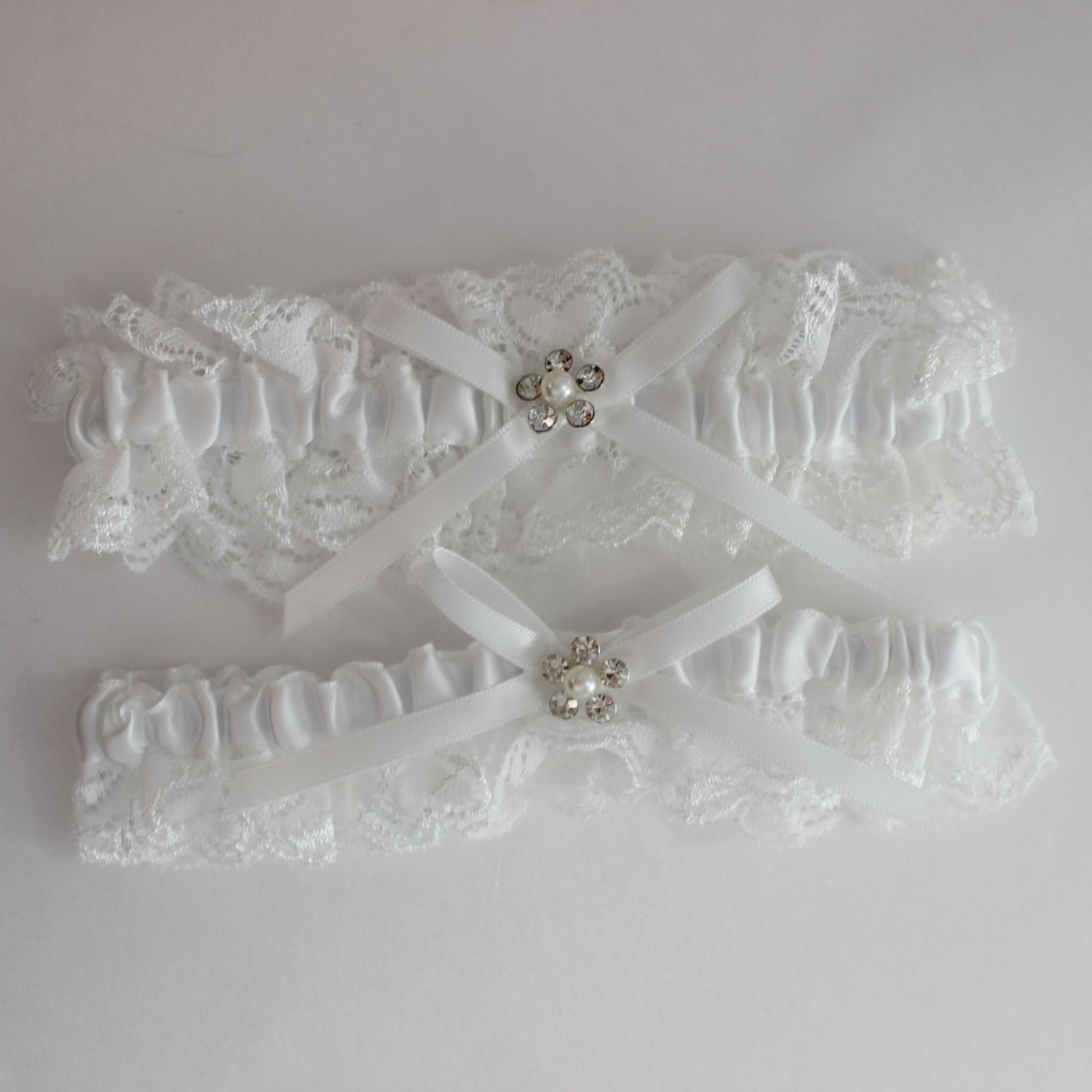 Two white lace bridal garters